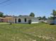 A side view of the property showing the lawn and white exterior with a dark roof at 6 Bahia Trace Loop, Ocala, FL 34472