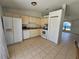 Kitchen with white appliances and tile flooring, with a view into the living room at 6 Bahia Trace Loop, Ocala, FL 34472