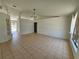 Open-concept living space with tile floors and a modern light fixture at 6 Bahia Trace Loop, Ocala, FL 34472