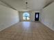 Spacious living room with neutral tile floors, a large front window, and recessed lighting at 6 Bahia Trace Loop, Ocala, FL 34472
