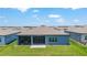 Aerial shot of backyard featuring patio and screened lanai with view of neighboring homes and blue sky at 6046 Sw 86Th Cir, Ocala, FL 34481