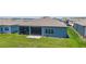 Aerial shot of backyard featuring patio and screened lanai with view of neighboring homes and blue sky at 6046 Sw 86Th Cir, Ocala, FL 34481