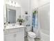 Bright bathroom features a double sink vanity and decorative shower curtain at 6046 Sw 86Th Cir, Ocala, FL 34481