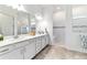 Bright bathroom featuring double sinks, white cabinets, and a walk-in shower at 6046 Sw 86Th Cir, Ocala, FL 34481