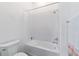 Clean bathroom with a shower-tub combo and white tile at 6046 Sw 86Th Cir, Ocala, FL 34481