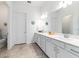 Spacious bathroom featuring double sinks, white cabinets, and tile flooring at 6046 Sw 86Th Cir, Ocala, FL 34481