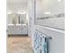 Elegant bathroom showcasing double vanities, a tiled shower, and neutral decor at 6046 Sw 86Th Cir, Ocala, FL 34481