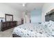 Bright bedroom featuring tile floors, a bed with nightstands, and a dresser at 6046 Sw 86Th Cir, Ocala, FL 34481