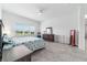 Comfortable bedroom features tile flooring, a ceiling fan, a dresser, and a comfortable bed at 6046 Sw 86Th Cir, Ocala, FL 34481
