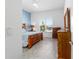Cozy bedroom with natural light, wooden furniture, and blue accent wall at 6046 Sw 86Th Cir, Ocala, FL 34481