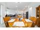 Wooden dining table with seating adjacent to a spacious kitchen and cozy living area at 6046 Sw 86Th Cir, Ocala, FL 34481