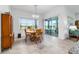 Bright dining area features a wooden table, chairs, and sliding glass doors to the patio at 6046 Sw 86Th Cir, Ocala, FL 34481