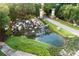 Community entrance with cascading waterfall, pond, and manicured landscaping at 6046 Sw 86Th Cir, Ocala, FL 34481