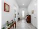 Elegant foyer with tile flooring, a vintage organ, and ample natural light streaming through the front door at 6046 Sw 86Th Cir, Ocala, FL 34481