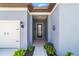 Inviting front entrance featuring a covered porch, decorative details, and access to the home's interior at 6046 Sw 86Th Cir, Ocala, FL 34481