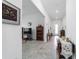 Long hallway with tile flooring, neutral walls, and views into adjacent rooms showcasing the open concept design at 6046 Sw 86Th Cir, Ocala, FL 34481