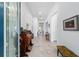 Bright and airy hallway with tiled floors, neutral walls, and elegant decor, showcasing the home's open layout at 6046 Sw 86Th Cir, Ocala, FL 34481