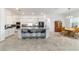 Modern kitchen with a large island, granite countertops, and stainless-steel appliances at 6046 Sw 86Th Cir, Ocala, FL 34481