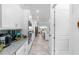 Long kitchen showcases white cabinetry, granite countertops, and stainless steel appliances at 6046 Sw 86Th Cir, Ocala, FL 34481