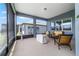 Inviting screened lanai with comfortable seating, neutral decor and a view of the backyard at 6046 Sw 86Th Cir, Ocala, FL 34481