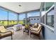 Enclosed lanai with comfortable wicker furniture, providing a relaxing outdoor space at 6046 Sw 86Th Cir, Ocala, FL 34481