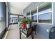 Spacious screened lanai with large windows and a view of the backyard and a table with plants at 6046 Sw 86Th Cir, Ocala, FL 34481