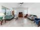 Bright living room with neutral decor, tile flooring, and comfortable seating arrangement at 6046 Sw 86Th Cir, Ocala, FL 34481