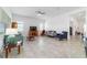Open-concept living room featuring tile flooring and a comfortable seating arrangement at 6046 Sw 86Th Cir, Ocala, FL 34481