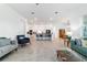 Bright living room showcasing an open floor plan with easy access to the kitchen and dining area at 6046 Sw 86Th Cir, Ocala, FL 34481
