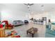 Spacious living room with an open floor plan and an adjacent kitchen featuring a large island at 6046 Sw 86Th Cir, Ocala, FL 34481