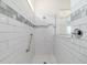 Modern walk-in shower showcasing white subway tile, a built-in bench, and a rainfall showerhead at 6046 Sw 86Th Cir, Ocala, FL 34481