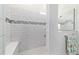 Modern walk-in shower features white subway tile, a built-in bench, and glass enclosure at 6046 Sw 86Th Cir, Ocala, FL 34481