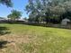 Large backyard with a wooden fence and mature trees, offering privacy at 6051 Ne 25Th Ave, Ocala, FL 34479