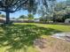 Large open backyard featuring a large tree providing shade for the home at 6051 Ne 25Th Ave, Ocala, FL 34479