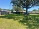 Spacious backyard with mature tree providing shade and an area for a shed at 6051 Ne 25Th Ave, Ocala, FL 34479