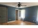 A bedroom featuring a sliding door and an open bathroom door at 6051 Ne 25Th Ave, Ocala, FL 34479