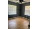 Bright bedroom with two windows and ceiling fan for ventilation at 6051 Ne 25Th Ave, Ocala, FL 34479
