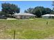 The yard of this home is spacious and freshly cut, located in a quite neighborhood at 6051 Ne 25Th Ave, Ocala, FL 34479