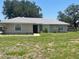 Well-maintained single story home featuring a new metal roof and manicured front yard at 6051 Ne 25Th Ave, Ocala, FL 34479