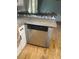 Kitchen featuring a dishwasher and concrete countertops with wooden floors and grey accents at 6051 Ne 25Th Ave, Ocala, FL 34479