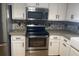 Well-lit kitchen featuring stainless steel appliances and white cabinets with black hardware at 6051 Ne 25Th Ave, Ocala, FL 34479
