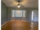 Living room area featuring a large bay window with new paint and a ceiling fan at 6051 Ne 25Th Ave, Ocala, FL 34479