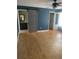 Open main bedroom featuring wood floors and sliding barn door entrance to the main bathroom at 6051 Ne 25Th Ave, Ocala, FL 34479