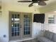 Covered patio with double doors and a ceiling fan at 6051 Ne 25Th Ave, Ocala, FL 34479