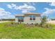 A beautiful backyard with green grass, landscaping, and a view of the house at 7337 Sw 89Th Ter, Ocala, FL 34481