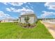 Green backyard featuring a well manicured lawn and landscaping with a light grey house exterior at 7337 Sw 89Th Ter, Ocala, FL 34481