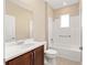 Bathroom featuring a vanity with stone countertop, sink, and a bathtub-shower combo at 7337 Sw 89Th Ter, Ocala, FL 34481