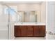Bright bathroom with a double sink vanity, stone countertop, and glass shower at 7337 Sw 89Th Ter, Ocala, FL 34481