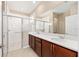 Bathroom with a double sink vanity, stone countertop, and glass shower stall at 7337 Sw 89Th Ter, Ocala, FL 34481