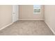 Neutral bedroom featuring plush carpet and a window providing ample natural light at 7337 Sw 89Th Ter, Ocala, FL 34481